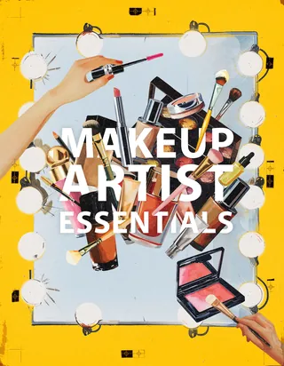 Makeup artist tools and products arranged on a lighted mirror