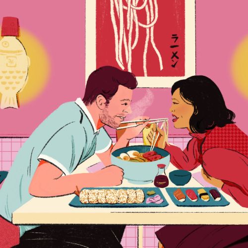 Man and woman eating sushi and noodles at a restaurant table.