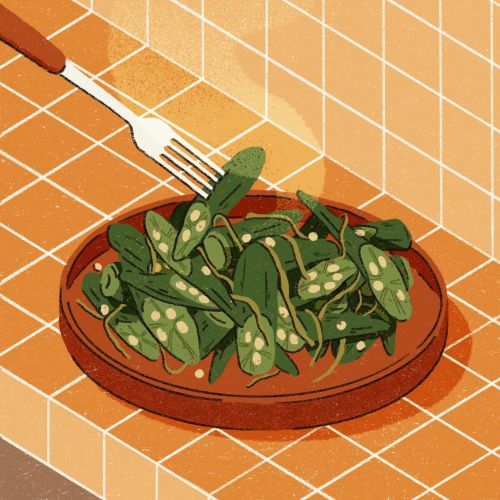 Bowl of fresh green snap peas with fork on orange tiled surface