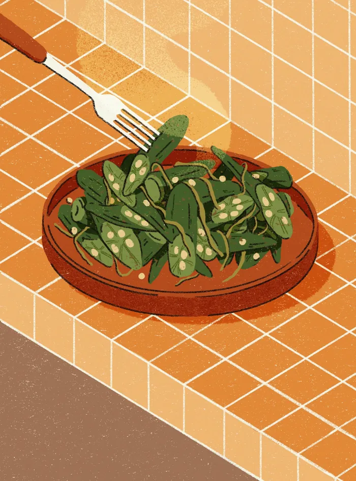 Bowl of fresh green snap peas with fork on orange tiled surface