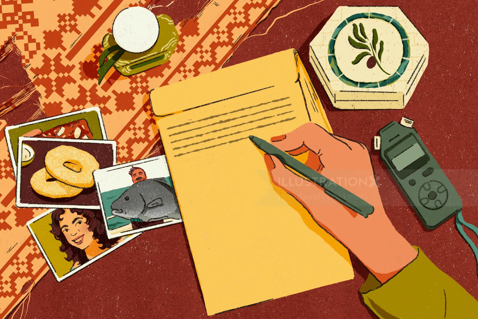 Hand writing letter next to photos, candle, and voice recorder.