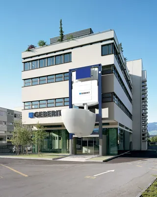 Modern Geberit office building with large toilet bowl sculpture outside