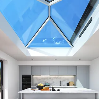 Modern kitchen with marble island under large glass roof light