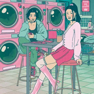 Two young women sitting in laundromat with pink and teal machines