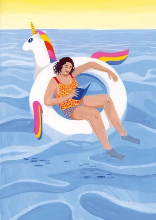 Woman reading book on unicorn float in the sea by Iratxe López de Munáin