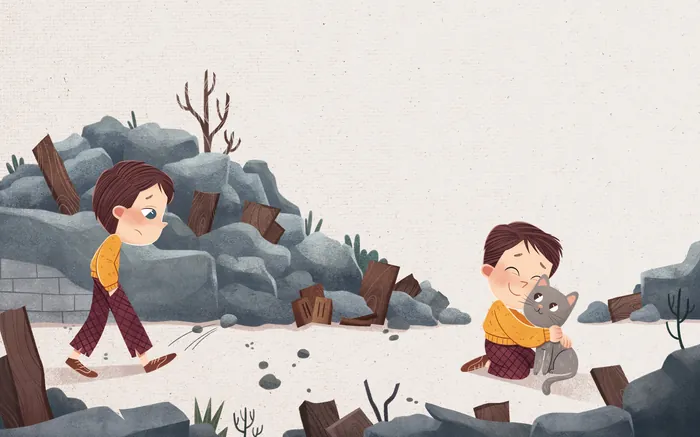 Boy playing with cat near rocks and wood debris
