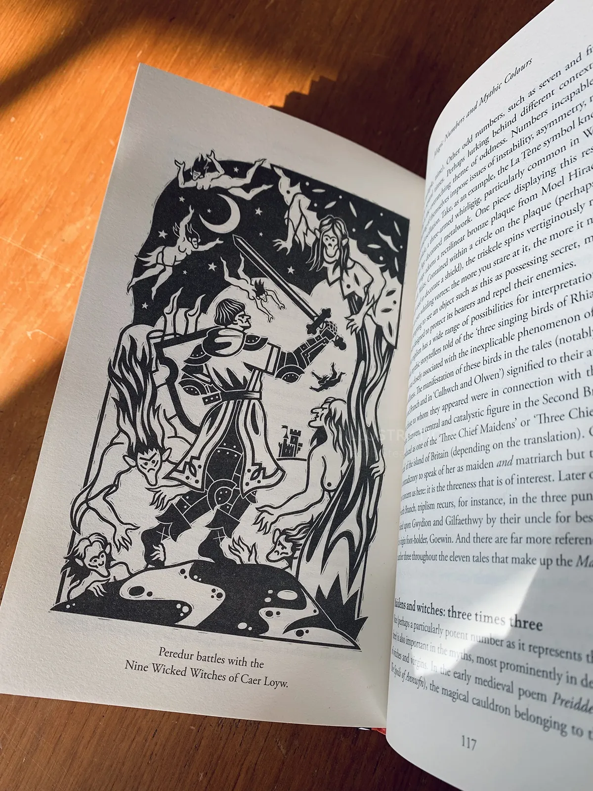 Black and white illustration of a knight with a sword amidst trees