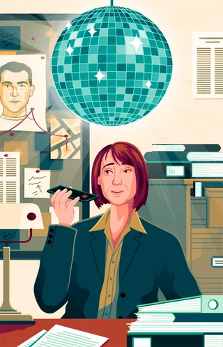 Individual holding a pen in office with disco ball overhead