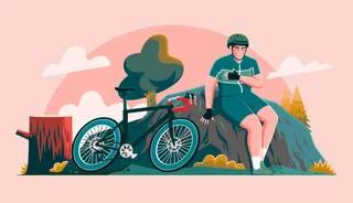 Man resting next to mountain bike in nature setting