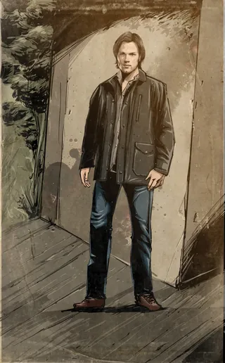 Man wearing a dark leather jacket standing indoors in dim light