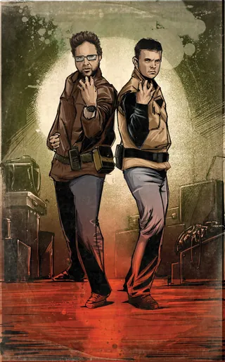 Two stylish men posing confidently back to back on stage with spotlights.