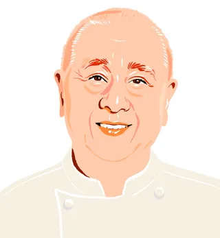 Smiling bald man in white chef uniform by Jessine Hein