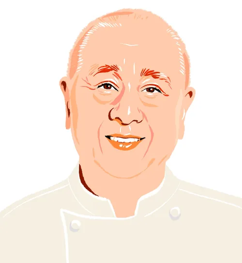 Smiling bald man in white chef uniform by Jessine Hein