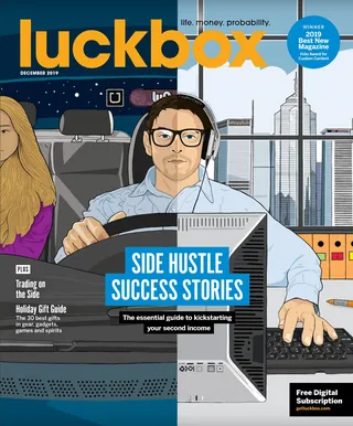 Man with glasses and headphones working on a computer at desk.