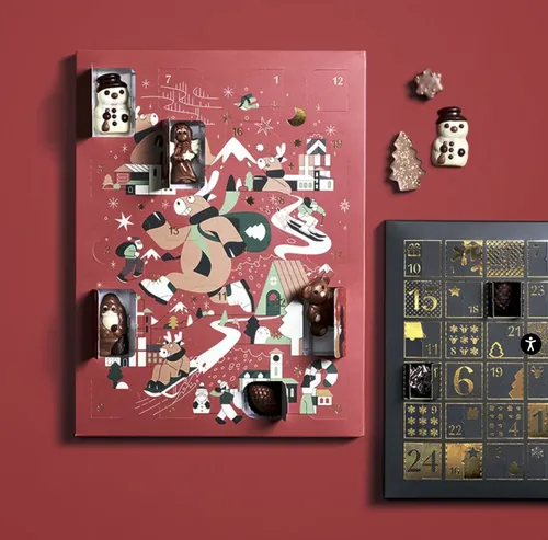 Advent calendar with chocolates and holiday-themed illustrations on red background