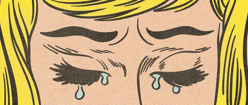 Close-up of a woman crying with tears on her cheeks