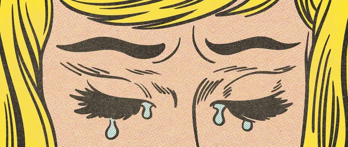 Close-up of a woman crying with tears on her cheeks