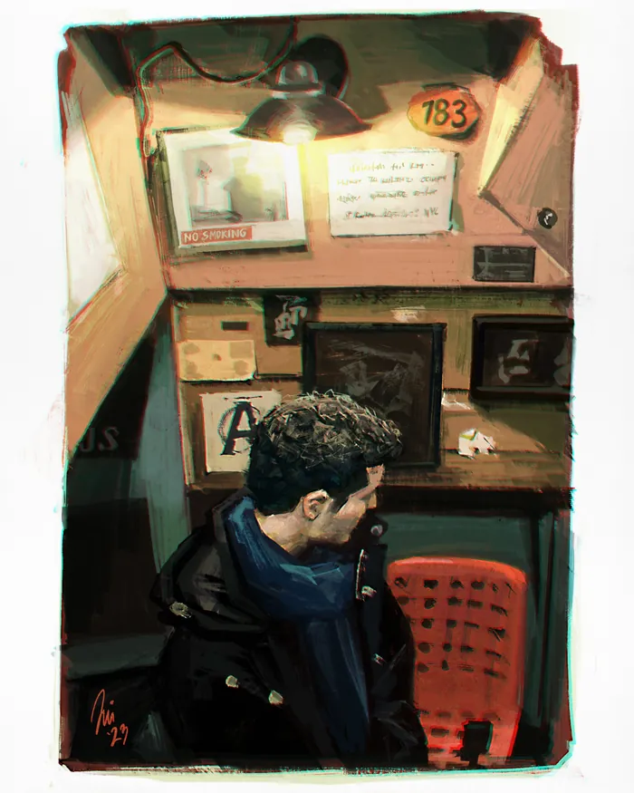 Man with blue scarf sitting in a small booth under warm light by Jui Talukder