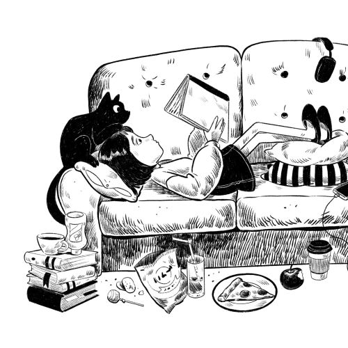 Girl lying on couch reading book with cat and snacks nearby