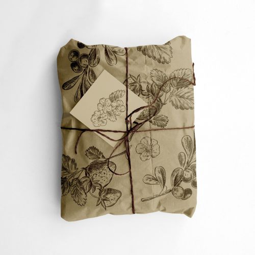 Package wrapped in botanical print paper tied with twine and tag