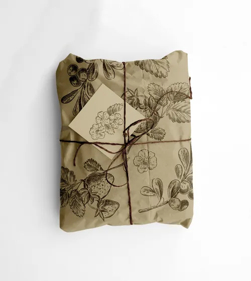 Package wrapped in botanical print paper tied with twine and tag