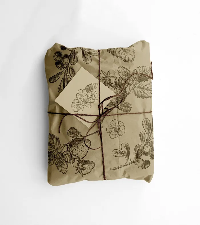 Package wrapped in botanical print paper tied with twine and tag