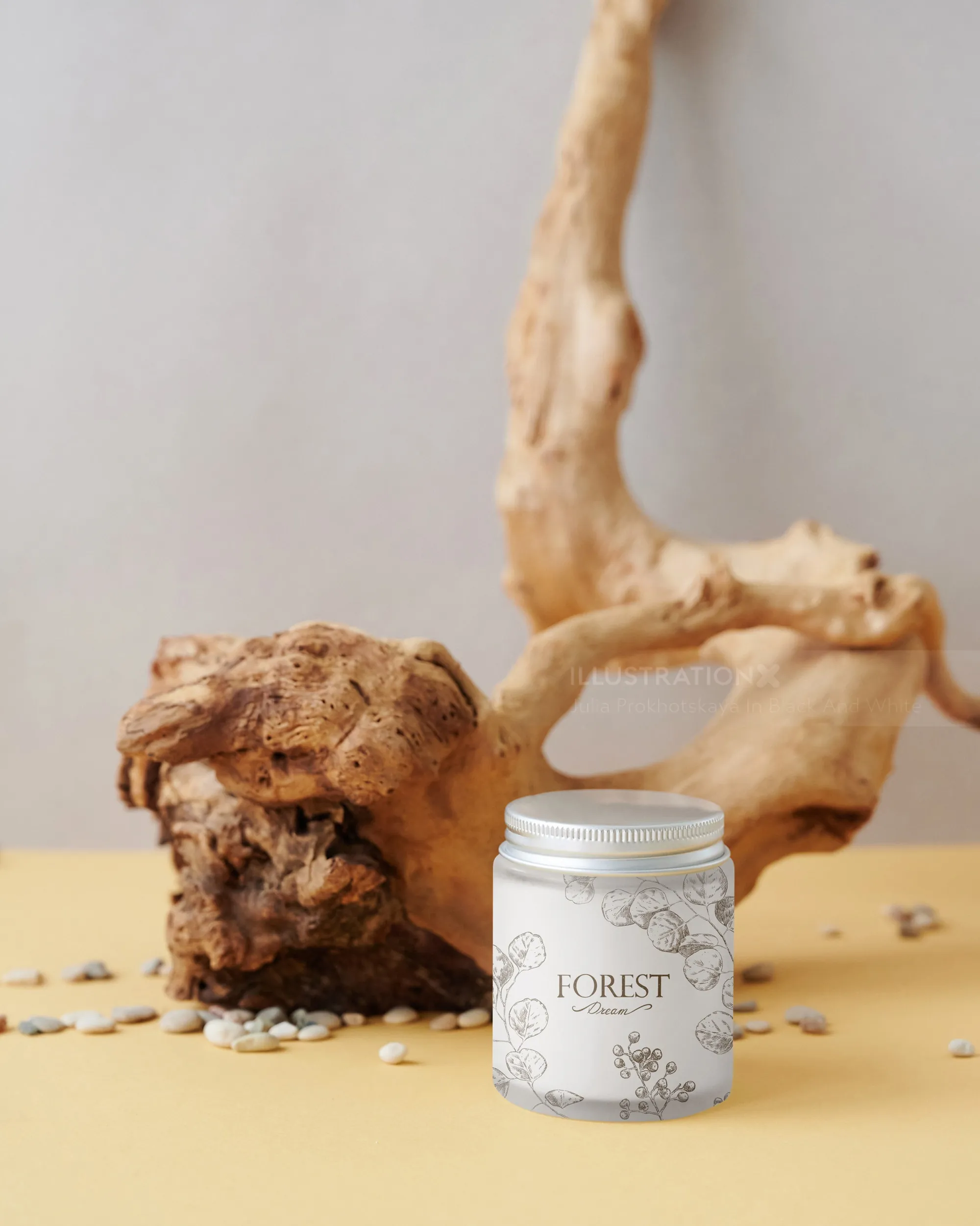 White Forest scented candle jar beside natural wood piece and scattered seeds