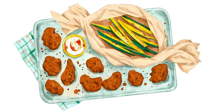 Tray with fried chicken wings, dipping sauces, and wrapped green beans