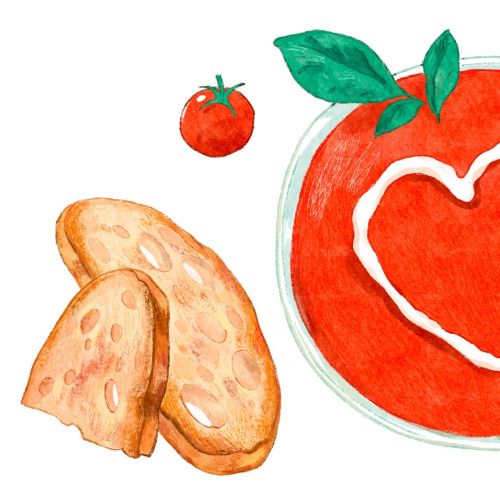 Bowl of tomato soup with cream heart, bread, and fresh tomatoes