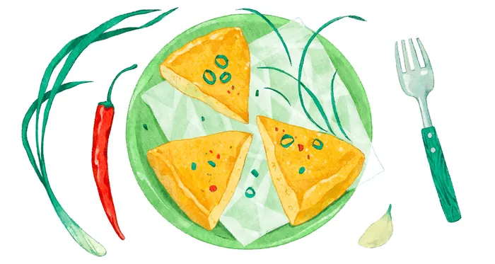 Three tortilla chips on green plate with chili, garlic, and fork
