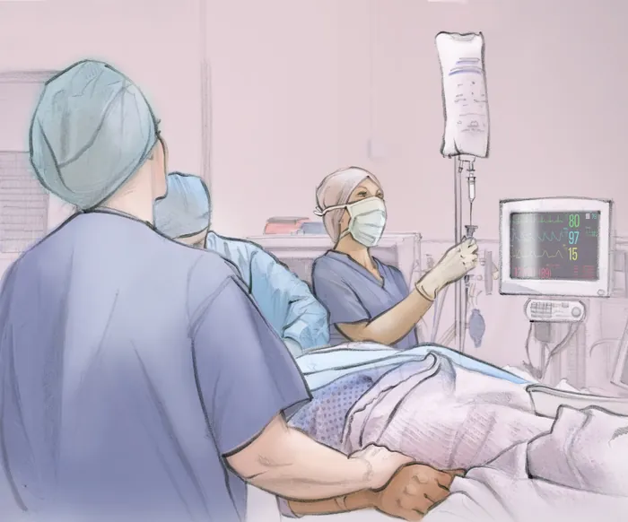 Medical staff monitoring patient receiving anesthesia in hospital room