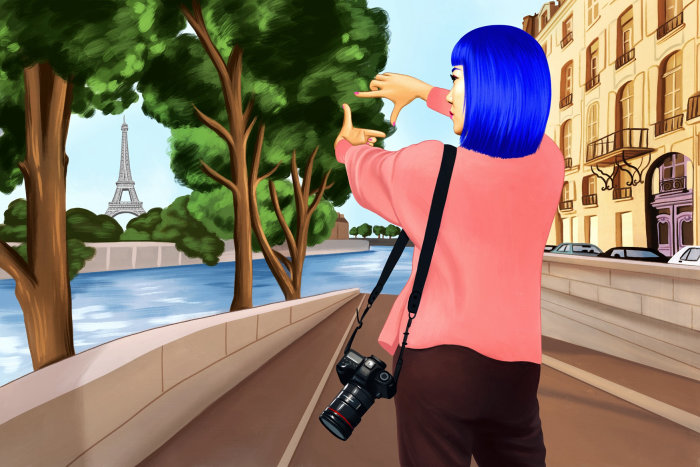 A woman taking a snap of the Eiffel Tower