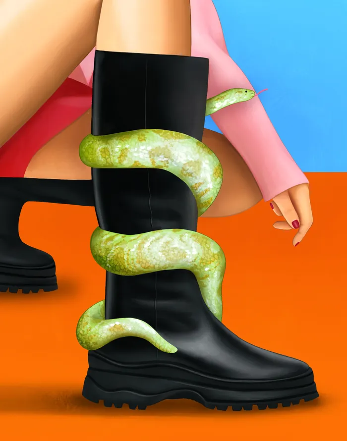 Green snake wrapped around black boot with person wearing pink sleeve