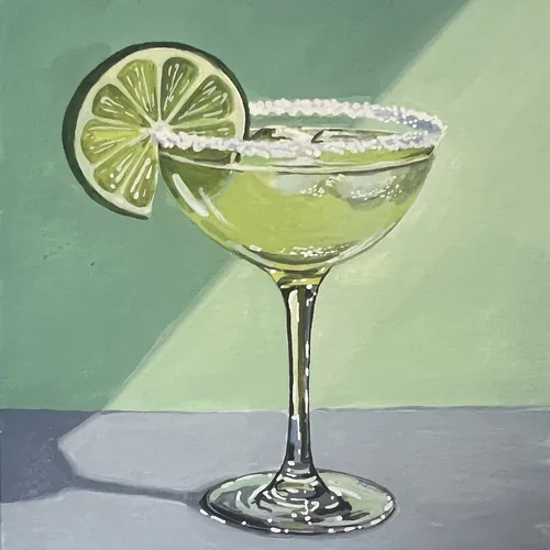Margarita cocktail in a glass with salted rim and lime garnish