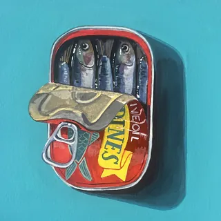 Open sardine tin with three fish inside on blue background