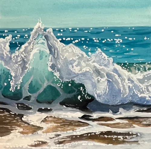 Ocean waves crashing on beach with white sea foam and blue water.