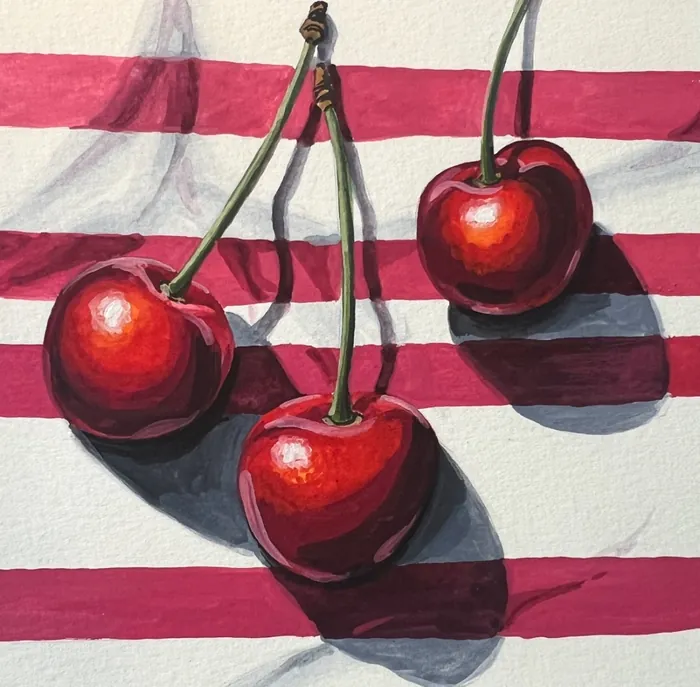 Three red cherries with stems casting shadows on striped red and white background
