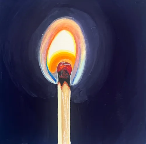 Burning matchstick flame glowing against dark background