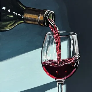 Pouring red wine into a clear wine glass