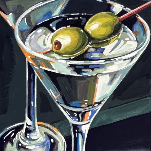 Martini glass with two green olives on a cocktail stick