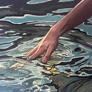 Hand touching water with ripples and light reflections