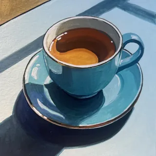 Blue cup and saucer with coffee on bright surface