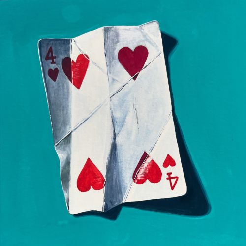 Folded four of hearts playing card casting shadow
