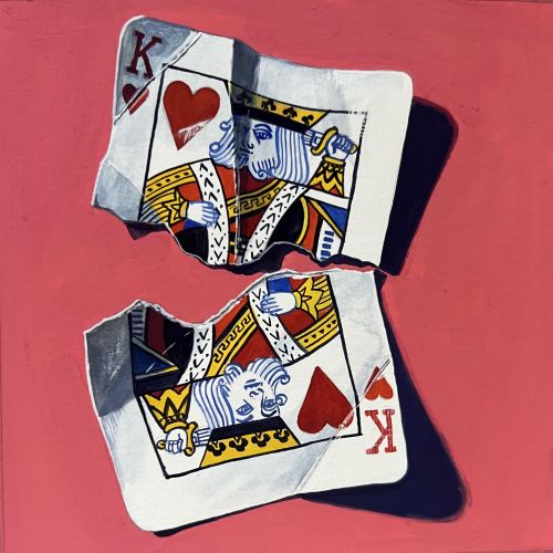 Torn King of Hearts playing cards on red surface casting shadows