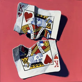 Torn King of Hearts playing cards on red surface casting shadows