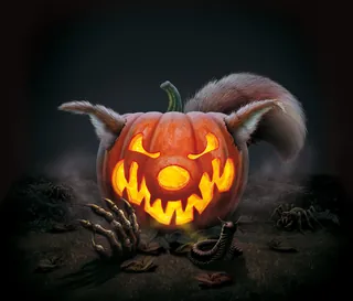 Glowing carved jack-o'-lantern with animal ears and skeletal hands by Kai Klimiont