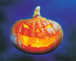 Carved glowing jack-o'-lantern pumpkin with sinister expression by Kai Klimiont