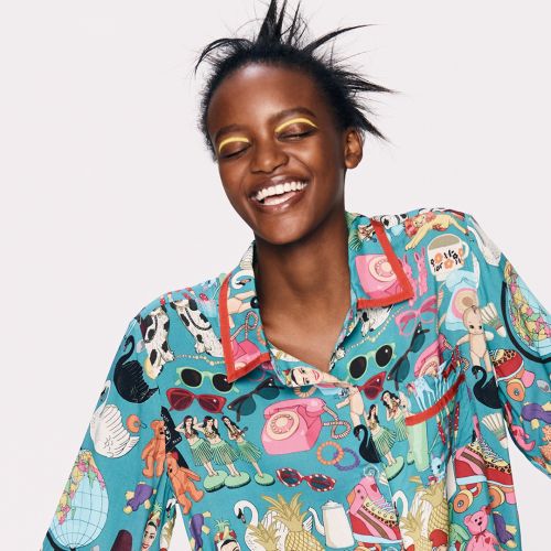 Joyful woman wearing colorful pajamas with playful illustrations by Karen Mabon