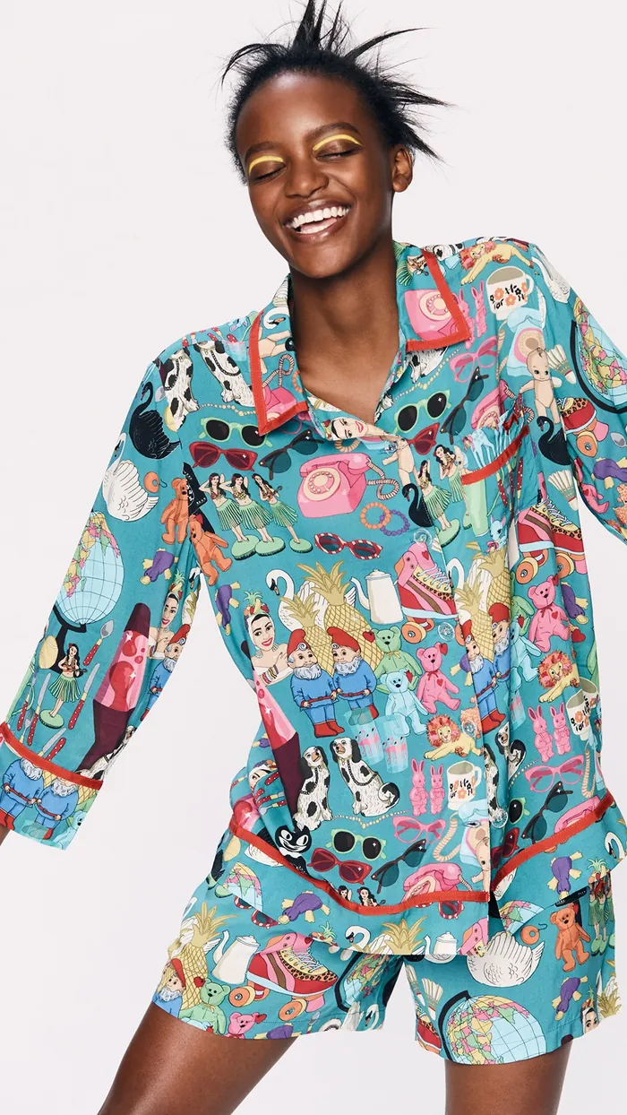 Joyful woman wearing colorful pajamas with playful illustrations by Karen Mabon