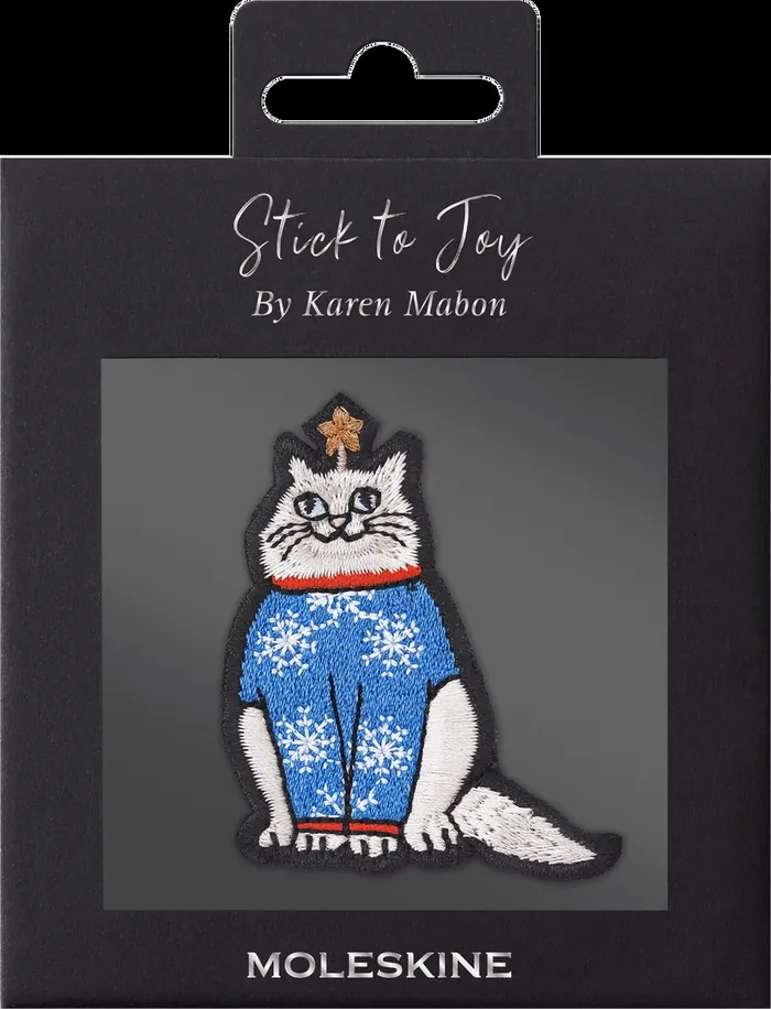White cat patch in blue snowflake sweater with red collar